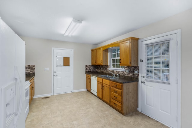 kitchen with white appliances, backsplash, and sink