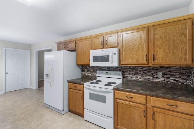 kitchen featuring white appliances and backsplash