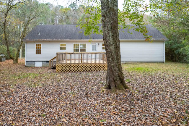 rear view of property featuring a wooden deck