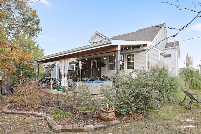 rear view of house with ceiling fan