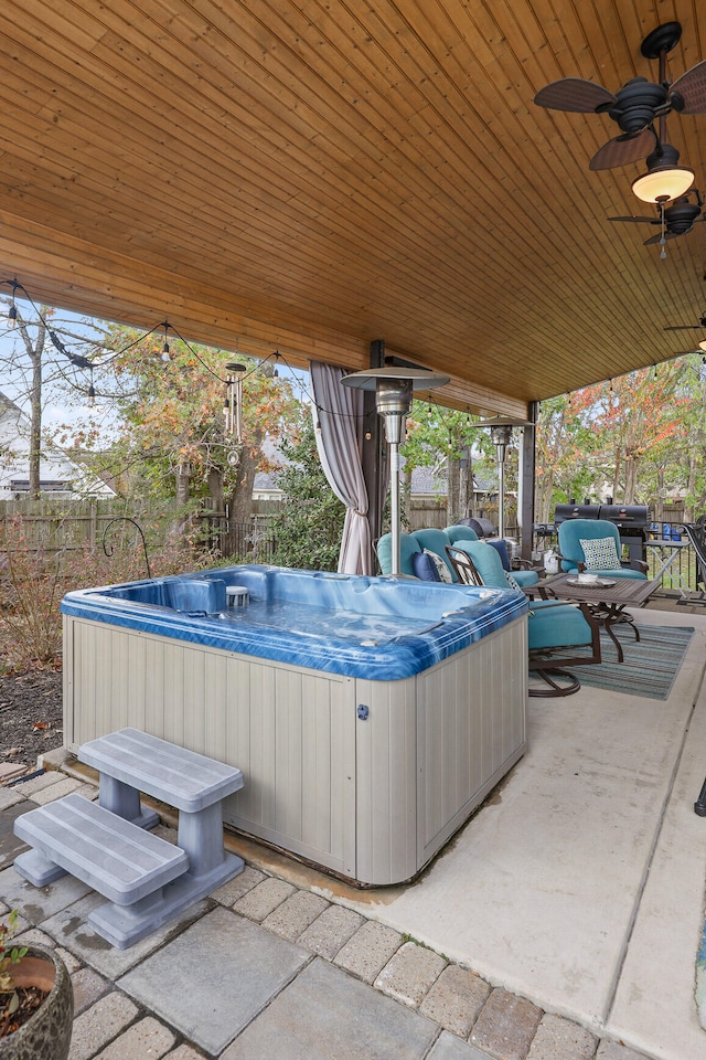 view of patio featuring ceiling fan and a hot tub