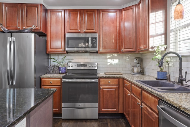 kitchen featuring backsplash, stone counters, sink, appliances with stainless steel finishes, and dark hardwood / wood-style flooring