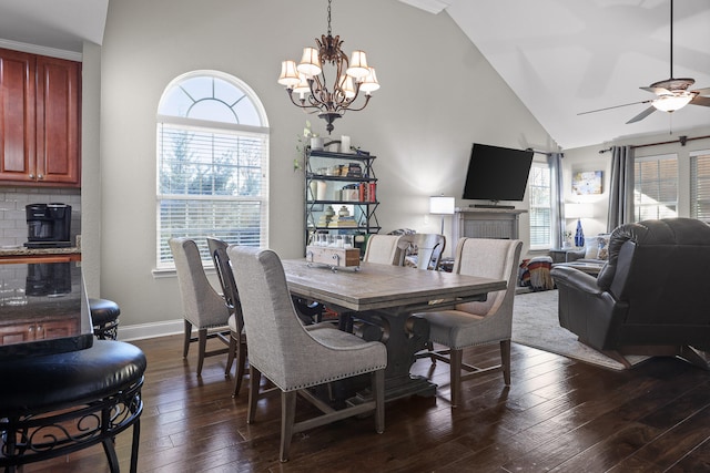 dining room with ceiling fan with notable chandelier, a healthy amount of sunlight, and dark hardwood / wood-style floors