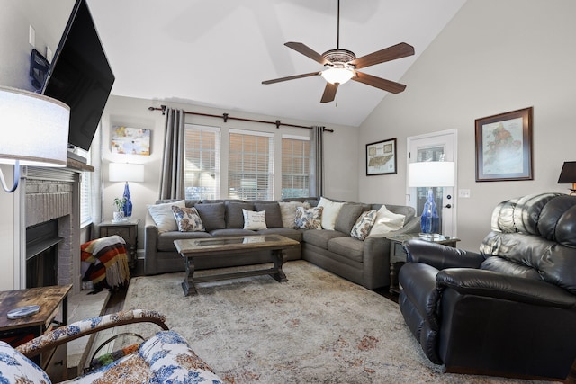 living room with high vaulted ceiling, a brick fireplace, and ceiling fan