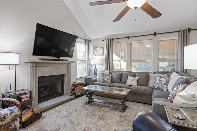 living room featuring ceiling fan, lofted ceiling, and a fireplace