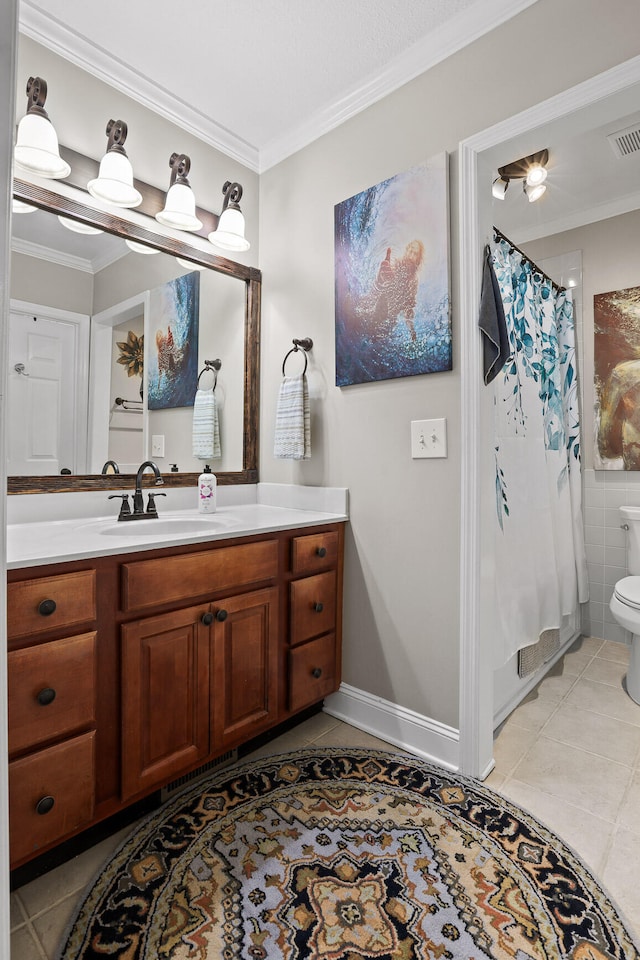 bathroom with tile patterned floors, vanity, and ornamental molding