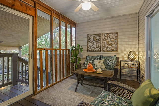 sunroom / solarium featuring ceiling fan and wood ceiling