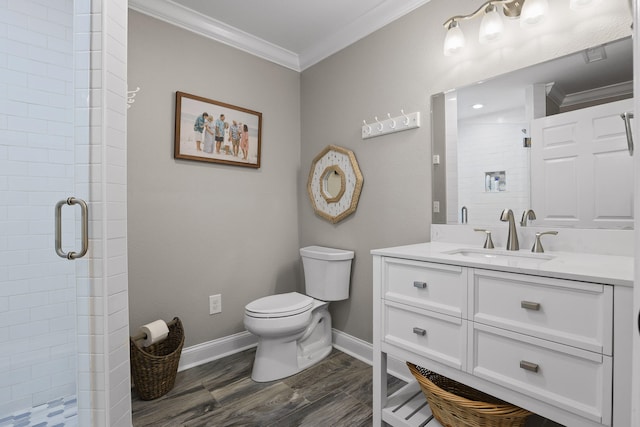 bathroom featuring an enclosed shower, ornamental molding, vanity, hardwood / wood-style floors, and toilet