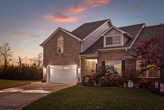 view of property featuring a yard and a garage