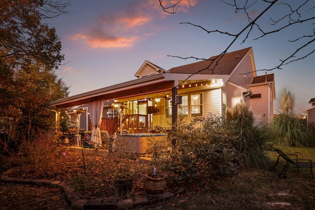 back house at dusk with a porch