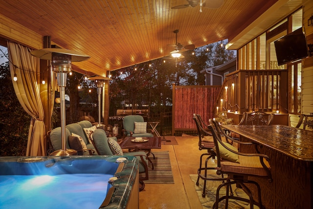 view of patio / terrace featuring ceiling fan and exterior bar