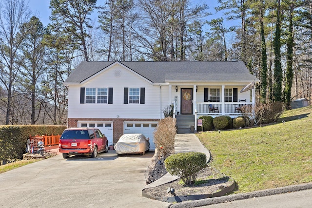 view of front of property with covered porch, a garage, brick siding, concrete driveway, and a front lawn