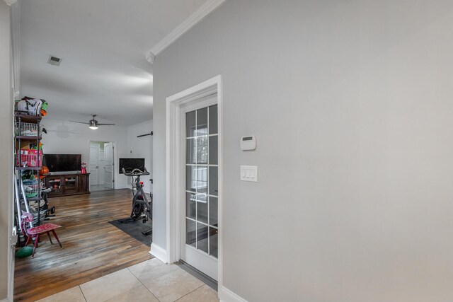 hall featuring ornamental molding and light wood-type flooring