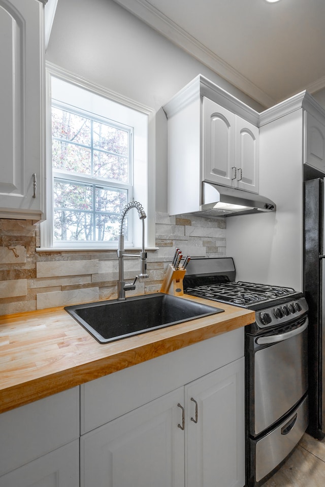 kitchen featuring backsplash, white cabinetry, sink, and stainless steel appliances