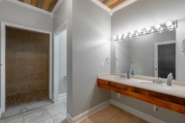 bathroom featuring sink, wooden ceiling, crown molding, and a tile shower