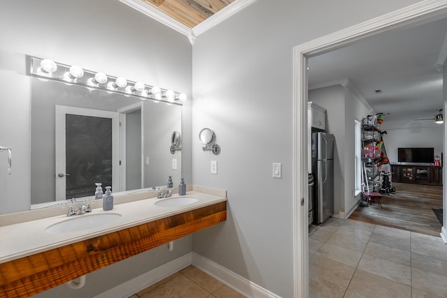 bathroom featuring tile patterned floors, sink, and ornamental molding