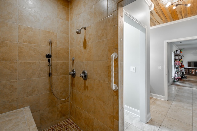 bathroom featuring tiled shower, wooden ceiling, tile patterned floors, and ornamental molding