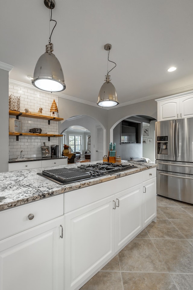 kitchen featuring white cabinetry, gas stovetop, tasteful backsplash, stainless steel fridge with ice dispenser, and pendant lighting