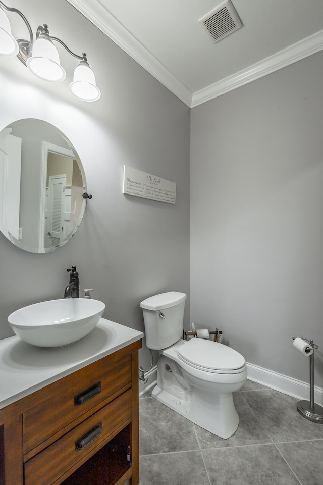 bathroom featuring tile patterned flooring, vanity, toilet, and ornamental molding