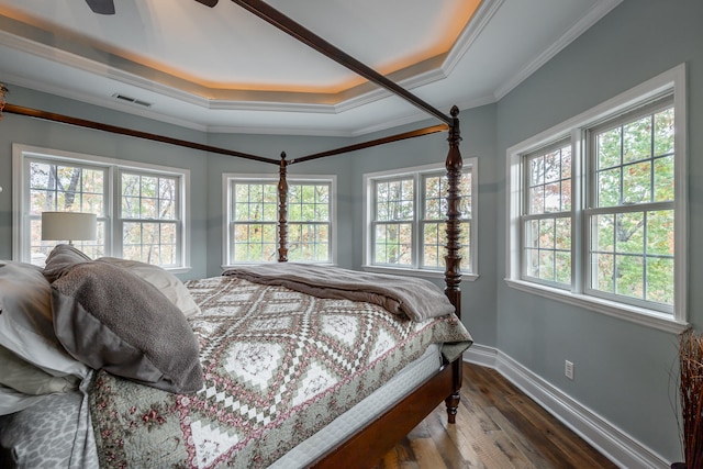 bedroom with ceiling fan, wood-type flooring, ornamental molding, and multiple windows