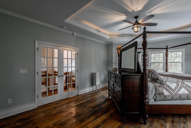 bedroom featuring french doors, a raised ceiling, dark hardwood / wood-style floors, ceiling fan, and ornamental molding