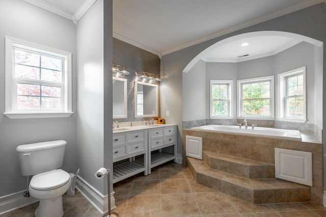 bathroom featuring tile patterned flooring, vanity, crown molding, and tiled tub