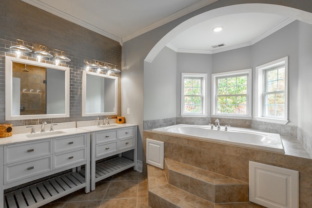 bathroom with plus walk in shower, tile patterned flooring, backsplash, vanity, and ornamental molding