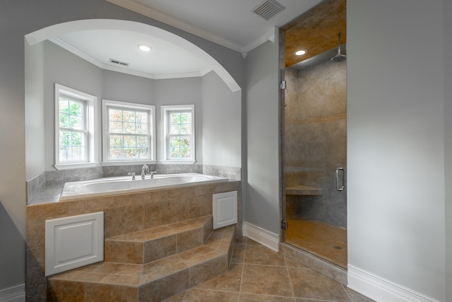 bathroom featuring separate shower and tub, tile patterned floors, and ornamental molding