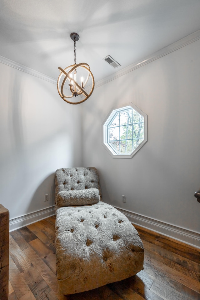 living area with dark hardwood / wood-style floors, ornamental molding, and a chandelier