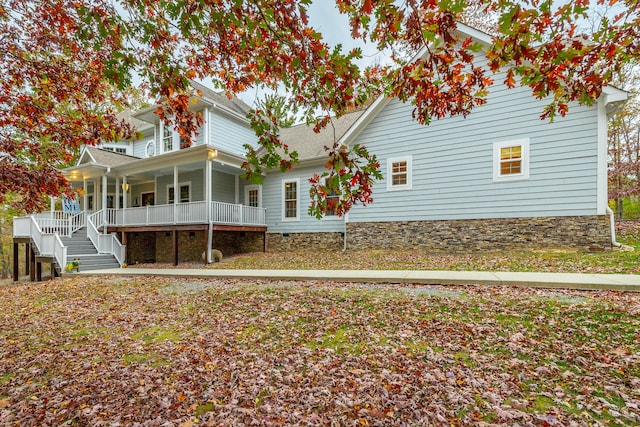 view of side of home with covered porch