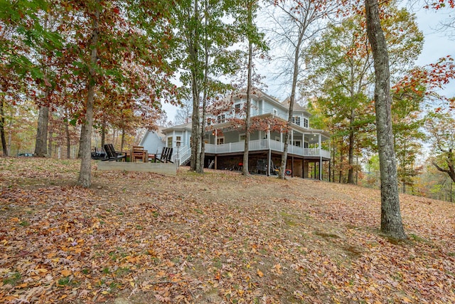 back of house with a deck and a sunroom