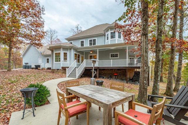 rear view of house with ceiling fan and a patio