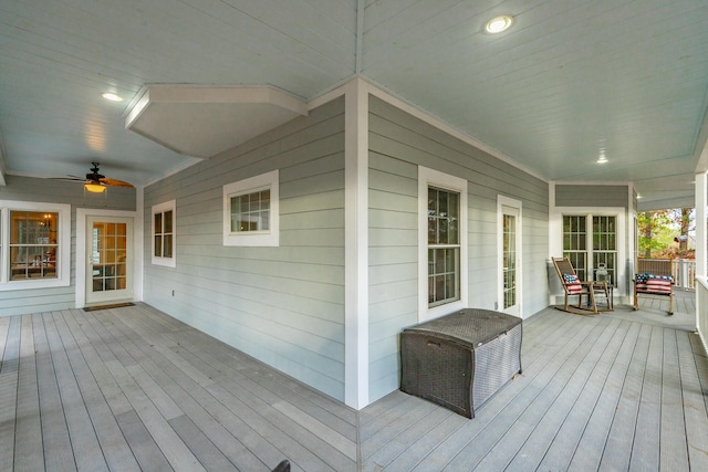 wooden terrace with covered porch and ceiling fan