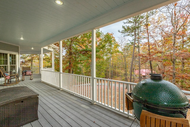 wooden terrace with a grill