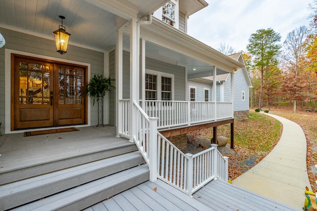 entrance to property with french doors and a porch