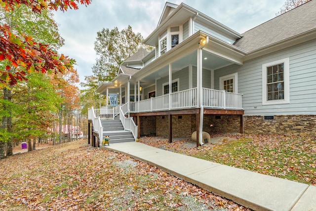 view of side of home with a porch