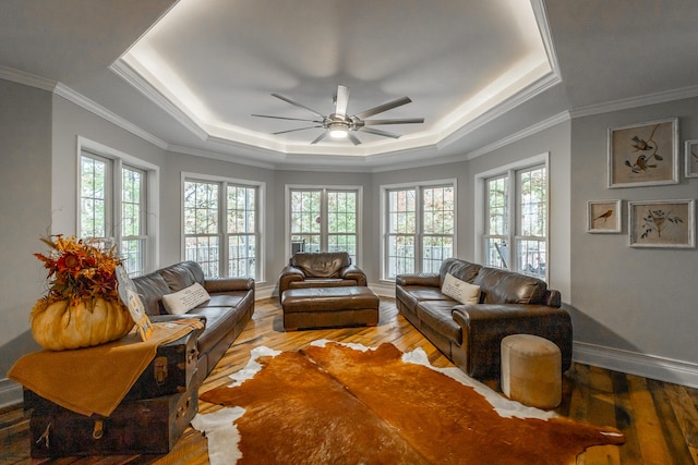 living room with hardwood / wood-style flooring, a wealth of natural light, and ornamental molding