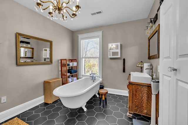 bathroom featuring a bathing tub, vanity, tile patterned floors, and a notable chandelier