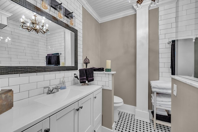 bathroom featuring vanity, crown molding, toilet, tasteful backsplash, and a chandelier