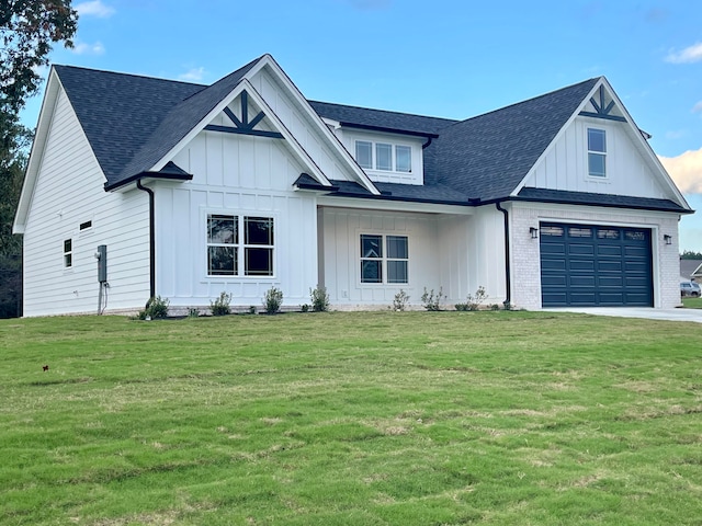 modern inspired farmhouse with a front yard and a garage