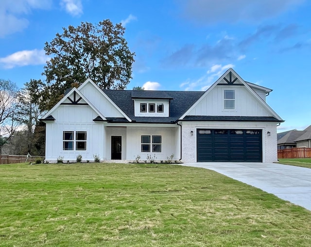 modern farmhouse style home featuring a front yard and a garage