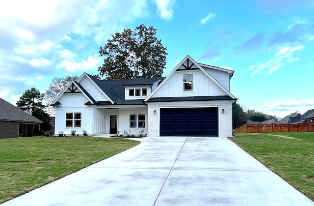 modern inspired farmhouse featuring a front yard and a garage