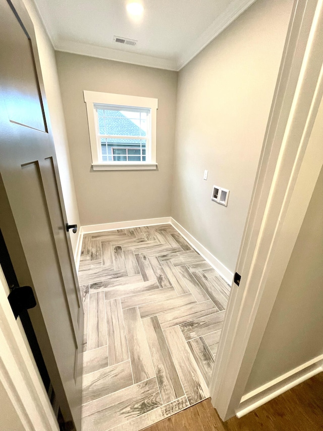 washroom featuring crown molding and hookup for a washing machine