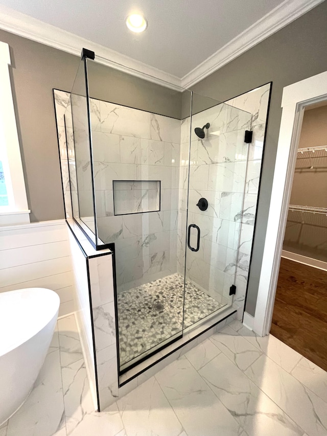 bathroom featuring ornamental molding and shower with separate bathtub