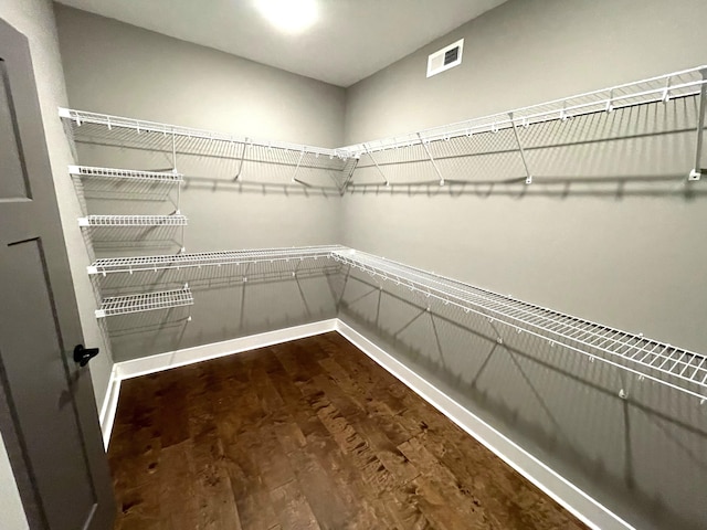 walk in closet featuring dark hardwood / wood-style flooring