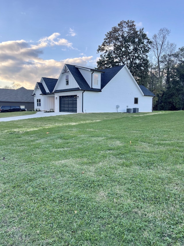 modern farmhouse with a front yard and a garage