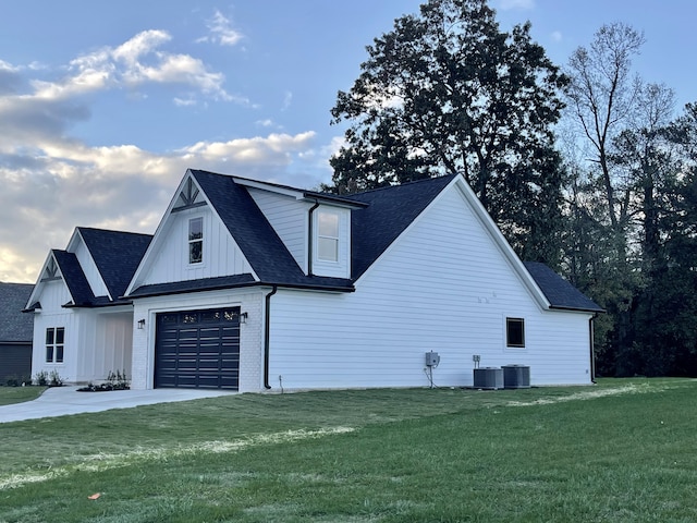 view of property exterior with a lawn, a garage, and central air condition unit