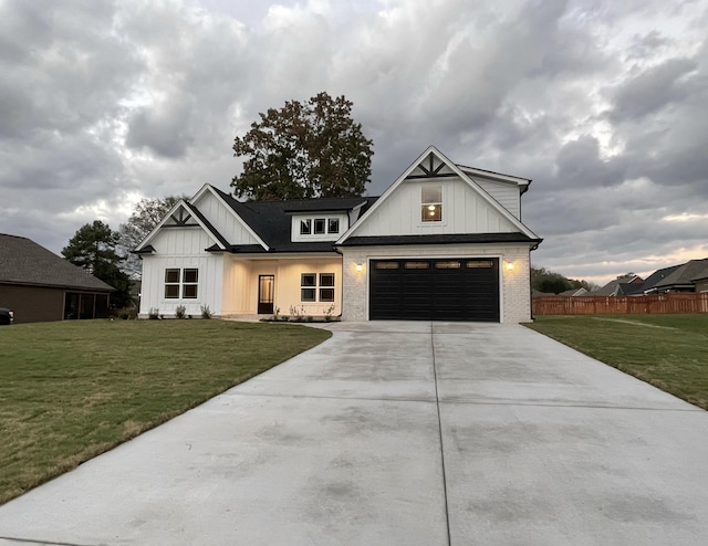 modern inspired farmhouse with a front lawn and a garage