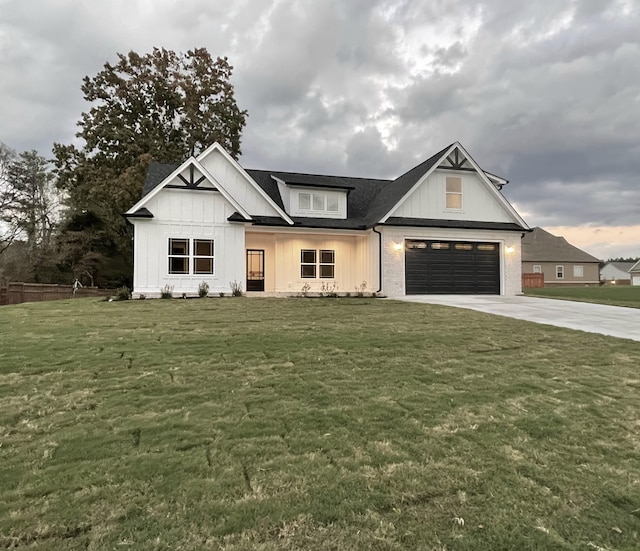 modern farmhouse style home featuring a garage and a front lawn