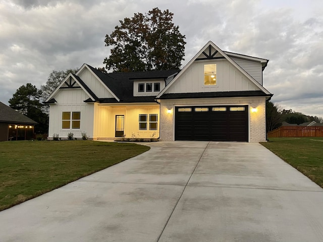 modern farmhouse with a garage and a front lawn